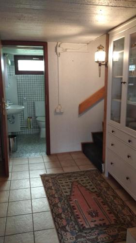 a bathroom with a sink and a toilet and a stairway at Bel Air in Norderstedt