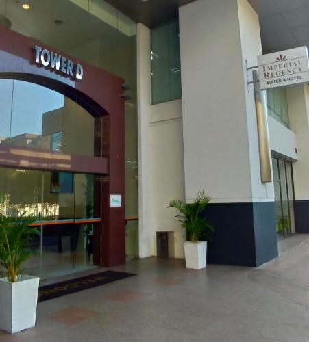 a lobby of a building with two potted plants at Imperial Regency Suites & Petaling Jaya in Kuala Lumpur