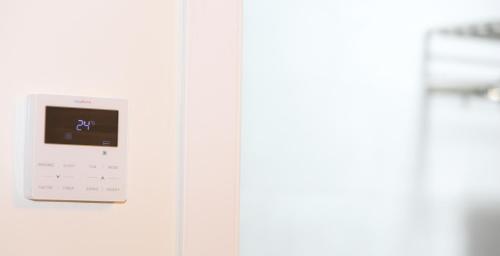an electronic clock on a white wall at H.PALMONES in Palmones