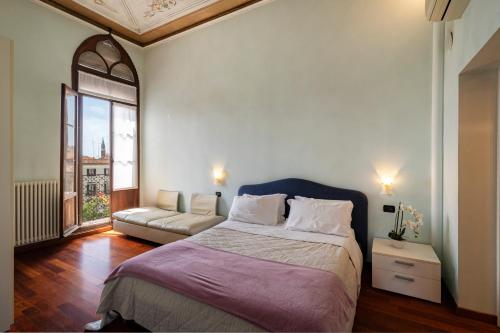 a bedroom with a large bed and a couch at Doge Morosini Palace in Venice