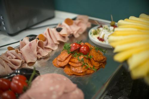 a tray filled with different types of food on a table at Hotel Civitas in Sopron