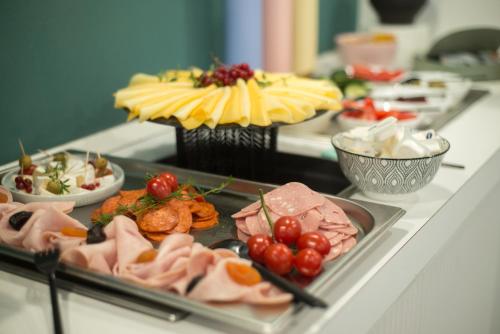 a buffet with different types of food on a table at Hotel Civitas in Sopron