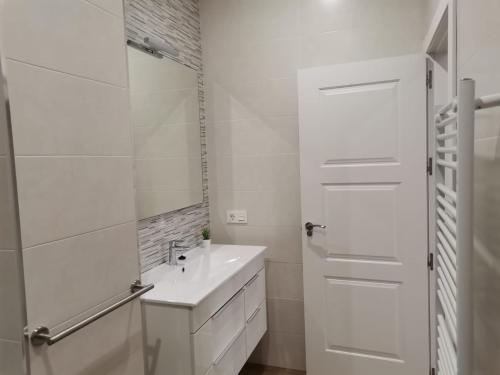 uma casa de banho branca com um lavatório e um espelho em Vivienda Turística Cumbre de Pontones em Pontones