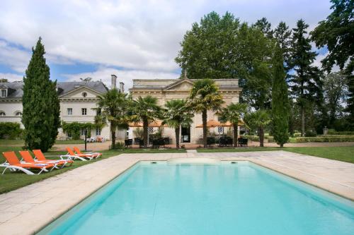 a pool with a pool table and chairs in front of a house at Hôtel Chateau Golf des Sept Tours by Popinns in Courcelles-de-Touraine