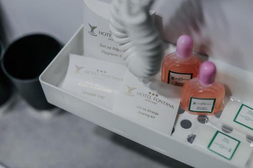 two bottles of medication in a box on a table at Hotel Fontana in Novi Sad