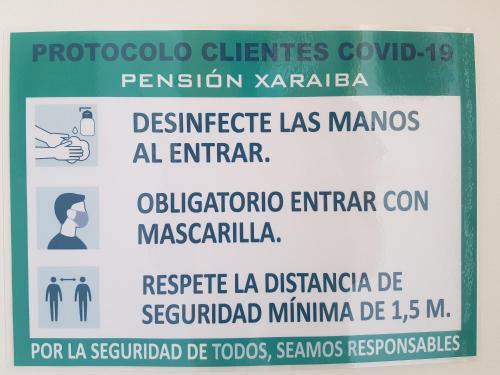 a sign on a wall with a sign for a sign at Hostal Xaraiba in Sanxenxo
