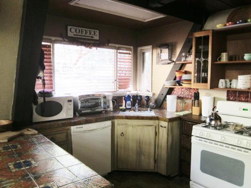 une cuisine avec un évier et une cuisinière four supérieur dans l'établissement Always Inn Idyllwild Vacation Cottages, à Idyllwild