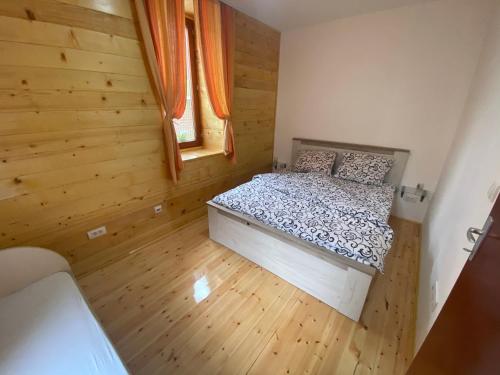 a small bedroom with a bed and a window at Stara kuća in Mokra Gora
