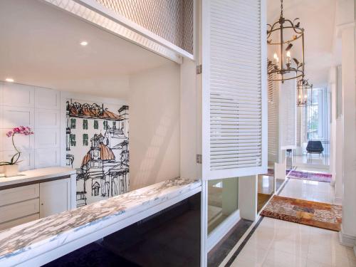 a kitchen with a bench in the middle of a room at Mercure Jakarta Batavia in Jakarta