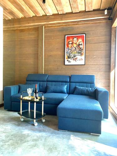 a blue couch in a living room with a table at Villa Gaida in Saulkrasti