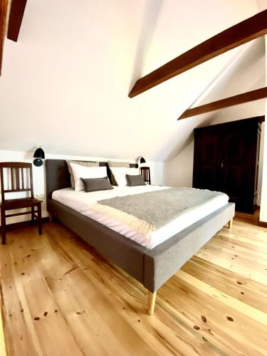 a bedroom with a bed and a wooden floor at Villa Gaida in Saulkrasti