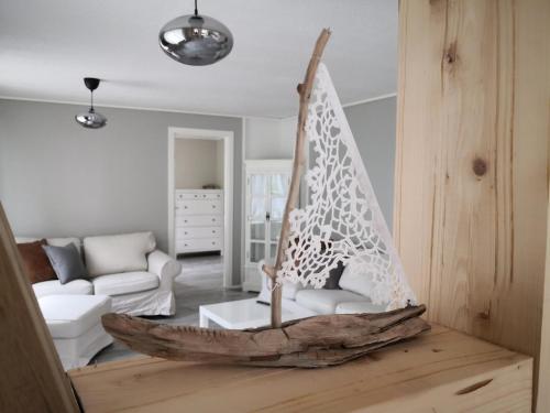 a wooden boat on a table in a living room at Old School på Eidslandet - exclusive apartment in Eidslandet