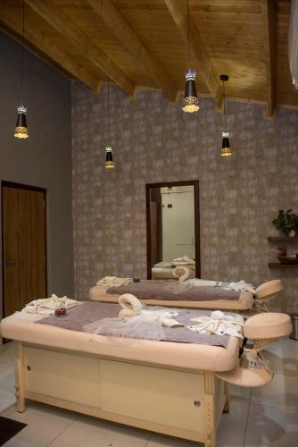 two beds in a room with a mirror at Sun Hotel and Resort, Mount Abu in Ābu Road