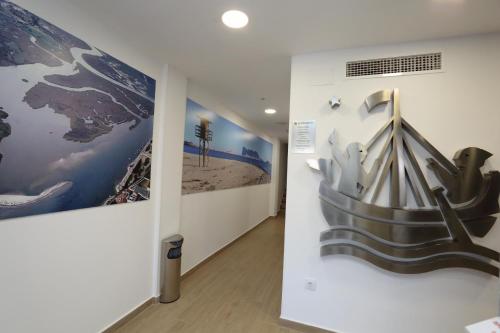 a hallway with two large paintings on the wall at H.PALMONES in Palmones