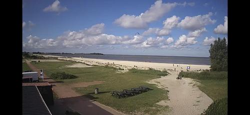 a view of a beach with a group of people at Friese Kust Villa in Workum