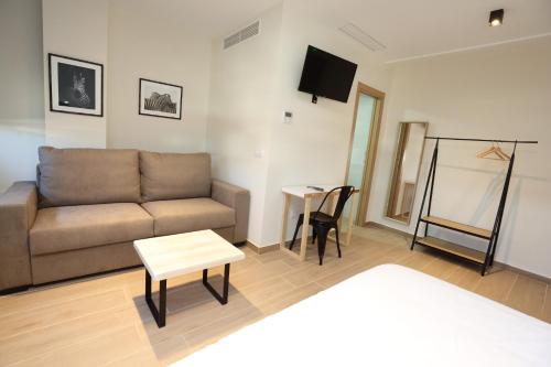 a living room with a couch and a table at H.PALMONES in Palmones