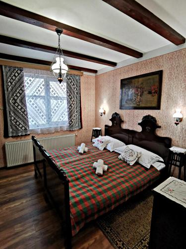 a bedroom with a bed with two teddy bears on it at Apartment Slavonska Kuća in Pleternica