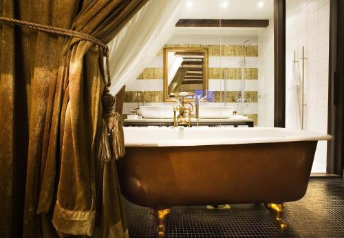 a large bathroom with a tub and a sink at Ulfsunda Slott in Stockholm