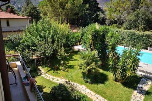 a garden with palm trees and a swimming pool at Villa Tiziana in Monreale
