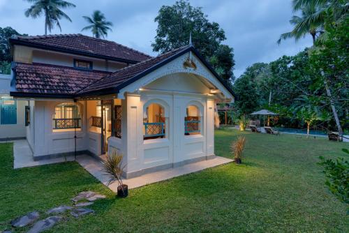 a home with a gazebo in a yard at STUTHI VILLA in Ahangama