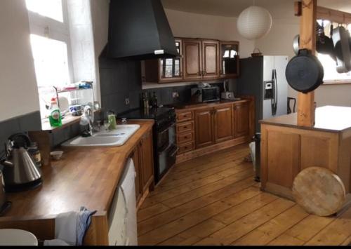 a kitchen with wooden floors and a stove top oven at Montrose Watertower in Montrose