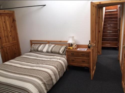 a bedroom with a bed and a table with a lamp at Montrose Watertower in Montrose