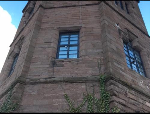 a tall brick tower with windows on a building at Montrose Watertower in Montrose