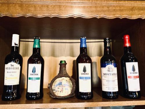 a row of wine bottles sitting on a shelf at Hotel Auerhahn in Grevenkrug