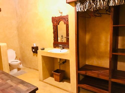 a bathroom with a sink and a mirror at Msafini Hotel in Lamu