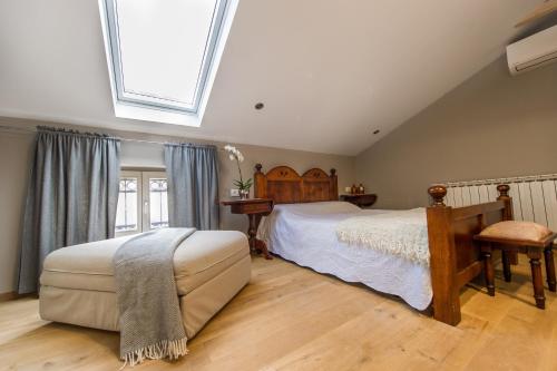 a bedroom with a large bed and a skylight at Villa Lav in Bale