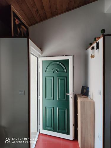 a green door in the middle of a room at Apartment M&M in Primošten