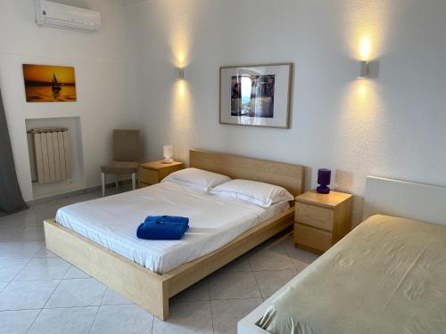 a bedroom with a bed with a blue bag on it at Villa Leucatia in Sant’Agata Li Battiati 