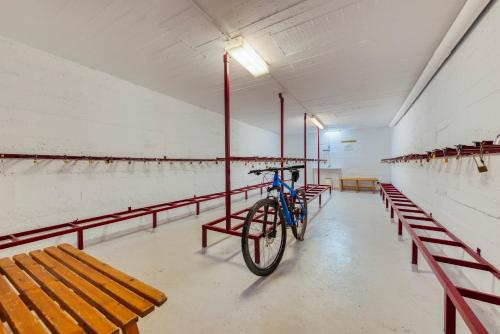 a bike parked in a room with benches at Hotel Viella in Vielha