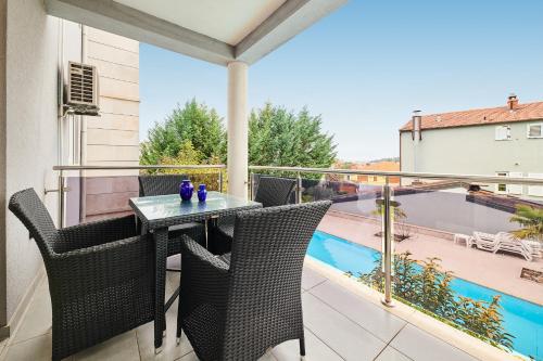 a patio with a table and chairs on a balcony at Ribarska Koliba - Stella Adria Villa in Pula