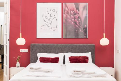 a bedroom with red walls and a bed with red pillows at Mint@Naschmarkt Premium Apartments in Vienna