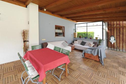 a living room with a table and a couch at Chalet Gloria - Doppel- und Mehrbettzimmer in Bruck an der Großglocknerstraße