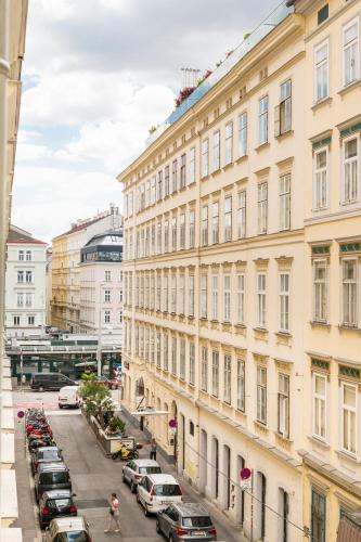 a city street with cars parked in front of buildings at Mint@Naschmarkt Premium Apartments in Vienna