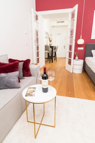 a living room with a bottle of wine on a table at Mint@Naschmarkt Premium Apartments in Vienna