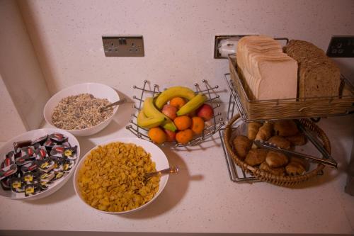a counter topped with bowls of bread and other food at Bridge Park Hotel in London