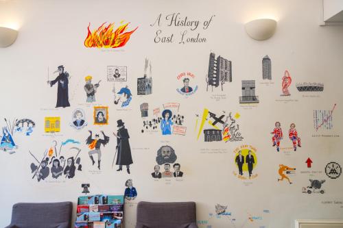 a wall with stickers on a wall at Park Villa Boutique Hostel in London