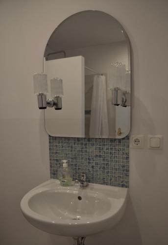 a bathroom with a sink and a mirror at Apartamenty u Majki 2 in Frydman