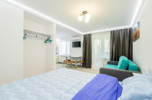 a bedroom with a blue bed and a couch at ARTAL Apartment on Obolonskyi Avenue 31 in Kyiv