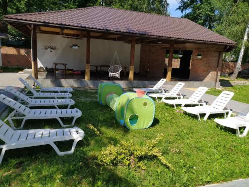 a group of lawn chairs and a gazebo at Svitiaz Griada in Szack