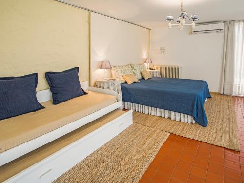 a bedroom with two beds with blue sheets at Quinta do Casal de S. Miguel de Soutelo in Vila Verde