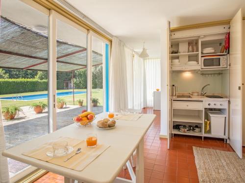 a kitchen with a table and a large window at Quinta do Casal de S. Miguel de Soutelo in Vila Verde