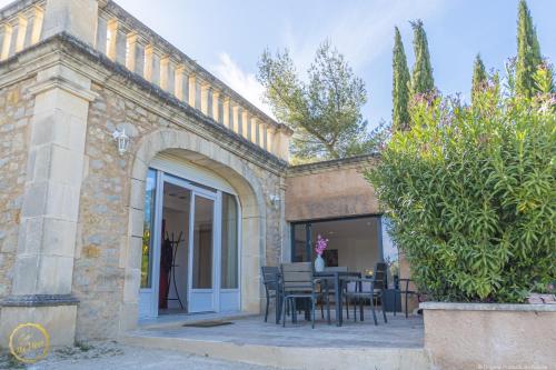 an open door to a patio with a table at Les Garrigues de la Vallée des Baux in Paradou