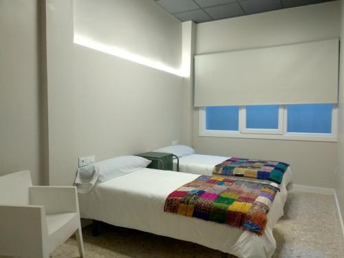 A bed or beds in a room at Acolá Rooms