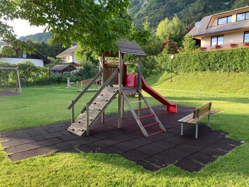 een speeltuin met een glijbaan in een tuin bij Apartments Rikli Rodine near Bled in Rodine