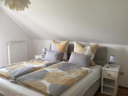 a bedroom with a large bed with two pillows at Ferienwohnung Luna in Pirna