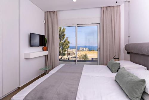 a bedroom with a large bed and a large window at Constantinos Villa, Sublime Island Εscape, By ThinkVilla in Panormos Rethymno
